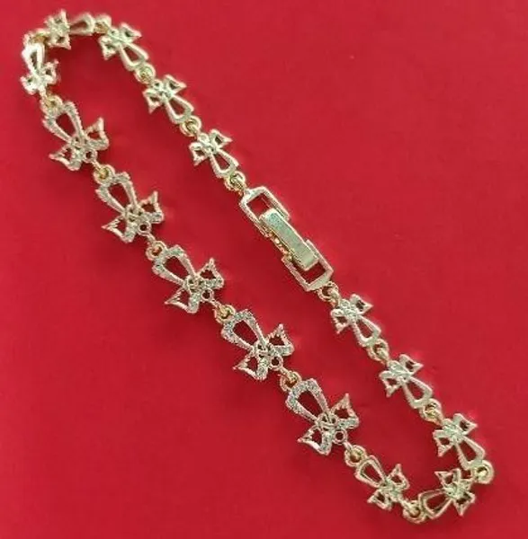 Pulsera dorada de moños con circonias