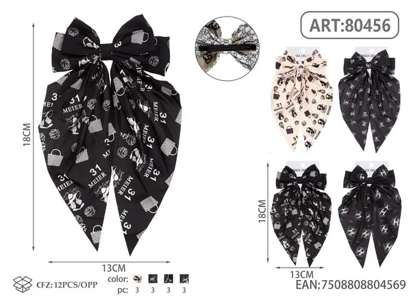 Broche para cabello de moño con colas largas y estampado negro